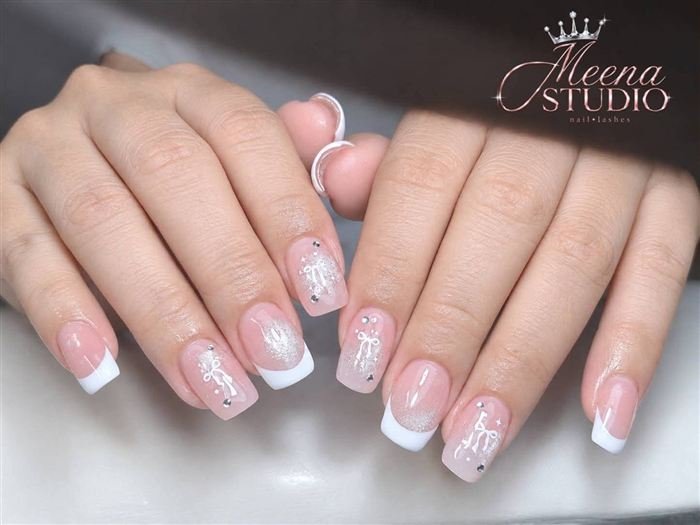 Sheer pink square nails with white French tips and hand-painted bows