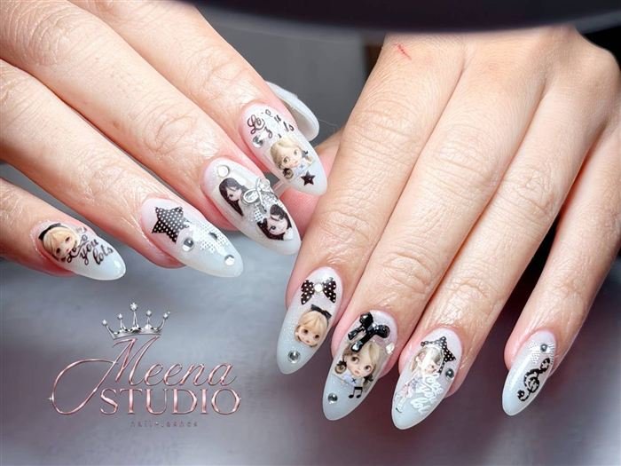 Milky almond nails with doll stickers, 'love you lots' lettering, bows and music notes