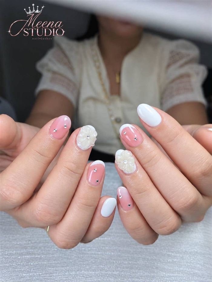 Short pink and white nails with pearl 3D flowers and crystals