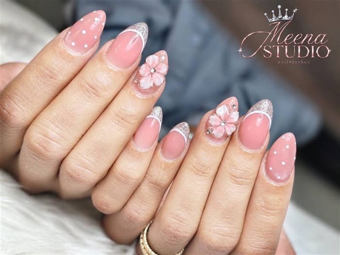 Pink almond nails with silver glitter French tips, polka dots and 3D flowers